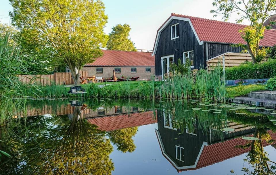 houten huis met rivier op de voorgrond bed en breakfast de vlotbrug